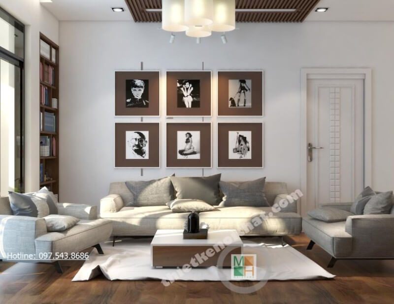 Không còn là những mảng tường đơn sắc thiếu tinh tế, kiến trúc sư lựa chọn trang trí thêm bằng những bức tranh treo tường phòng khách đầy lạ mắt